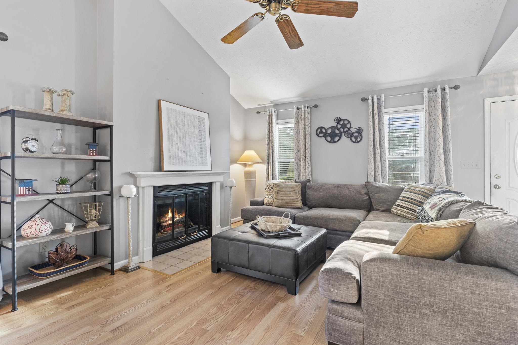 811 9th Avenue South North Myrtle Beach, SC 29582 - Photo 6 of 35 Living area with lofted ceiling, light wood finished floors, a fireplace with flush hearth, and ceiling fan