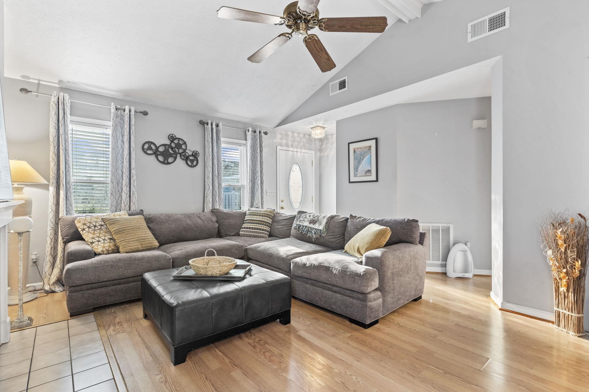 811 9th Avenue South North Myrtle Beach, SC 29582 - Photo 8 of 35 Living room featuring beamed ceiling, a ceiling fan, wood finished floors, healthy amount of natural light, and high vaulted ceiling