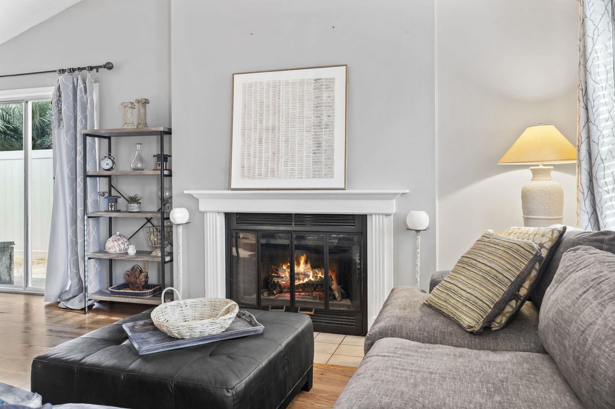 811 9th Avenue South North Myrtle Beach, SC 29582 - Photo 9 of 35 Living room featuring a glass covered fireplace, wood finished floors, and lofted ceiling