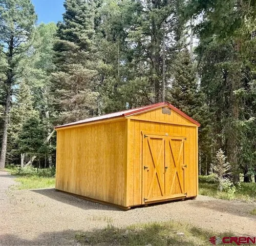 a view of a garage with a tree