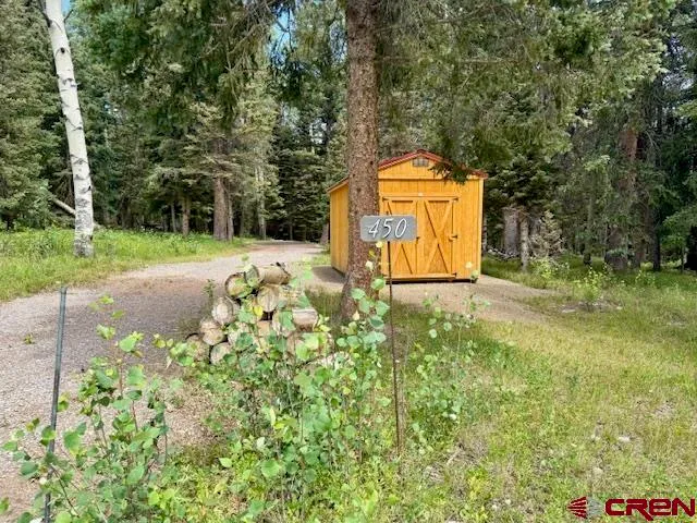 a backyard of a house with a yard and outdoor seating