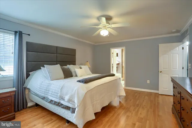 a bedroom with bed and wooden floor