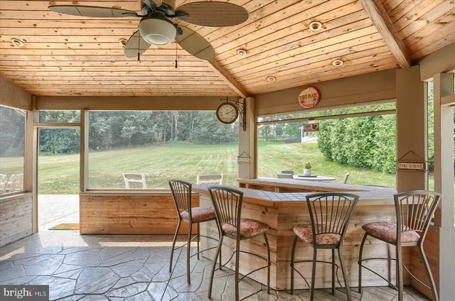 a view of a dining room with furniture and a porch