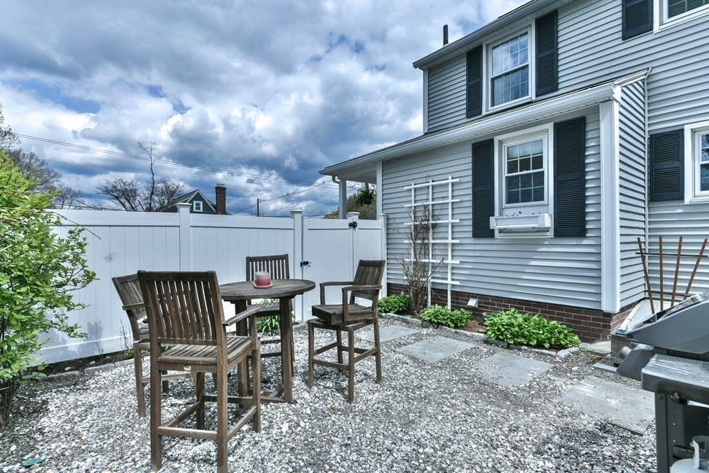 243 Beverly Road Worcester, MA 01605 - Photo 16 of 41 a view of a patio with table and chairs and floor to ceiling window