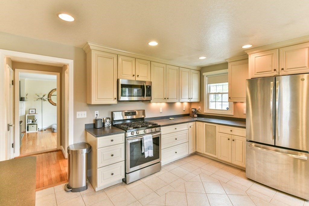 243 Beverly Road Worcester, MA 01605 - Photo 24 of 41 a kitchen with white cabinets stainless steel appliances and a island