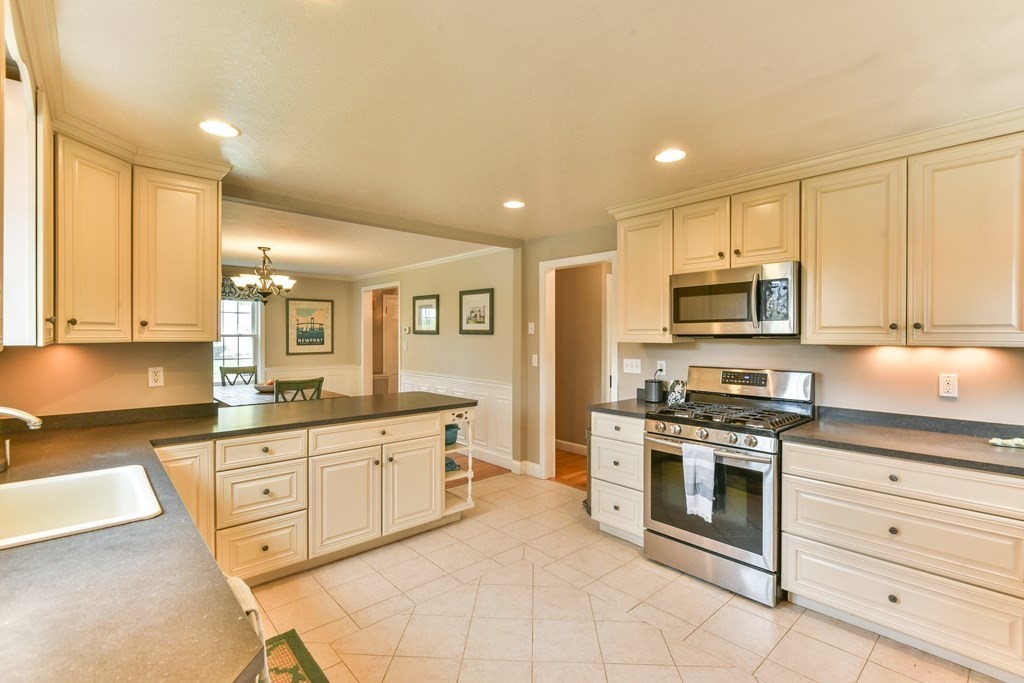 243 Beverly Road Worcester, MA 01605 - Photo 25 of 41 a large kitchen with stainless steel appliances granite countertop a stove and a sink