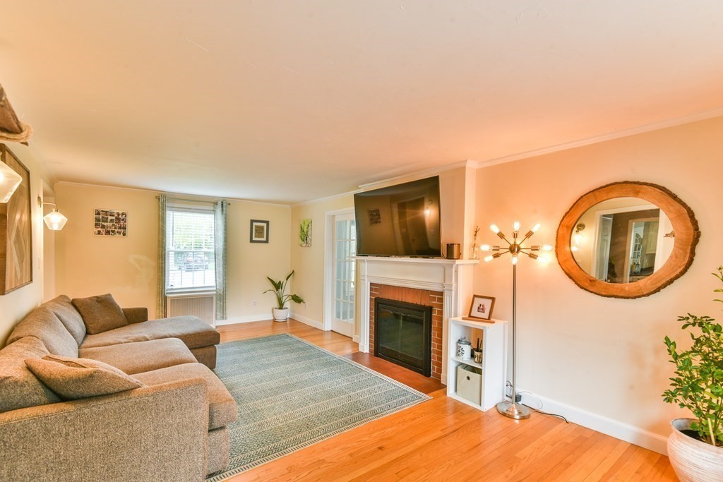 243 Beverly Road Worcester, MA 01605 - Photo 29 of 41 a living room with furniture a flat screen tv and a fireplace