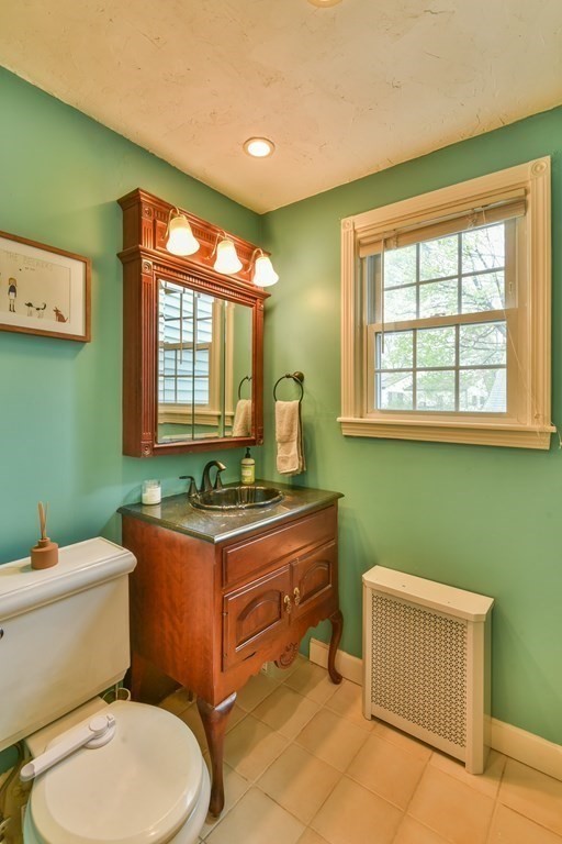 243 Beverly Road Worcester, MA 01605 - Photo 32 of 41 a bathroom with a toilet sink and mirror