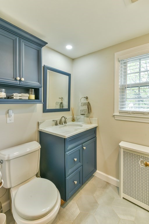 243 Beverly Road Worcester, MA 01605 - Photo 39 of 41 a bathroom with a toilet sink double vanity and mirror