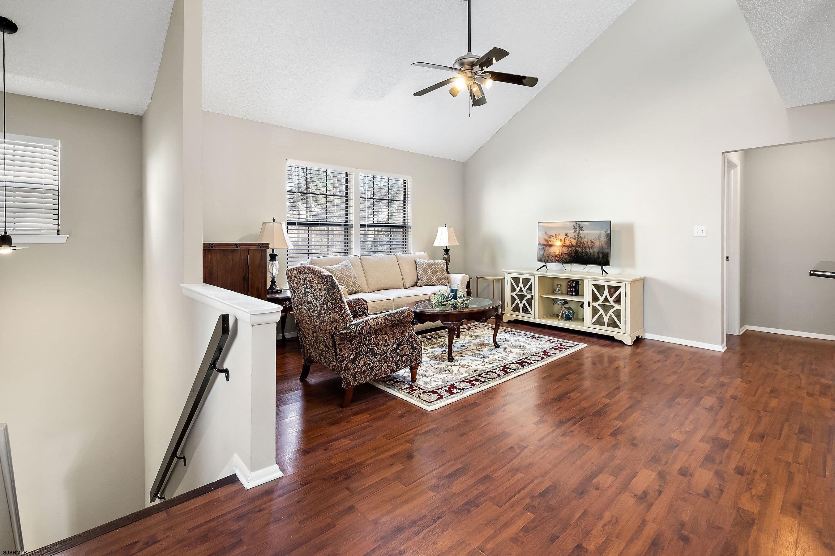 209 Daisy Court, Unit 209 Jackson, NJ 08527 - Photo 12 of 26 a living room with furniture flat screen tv and wooden floor