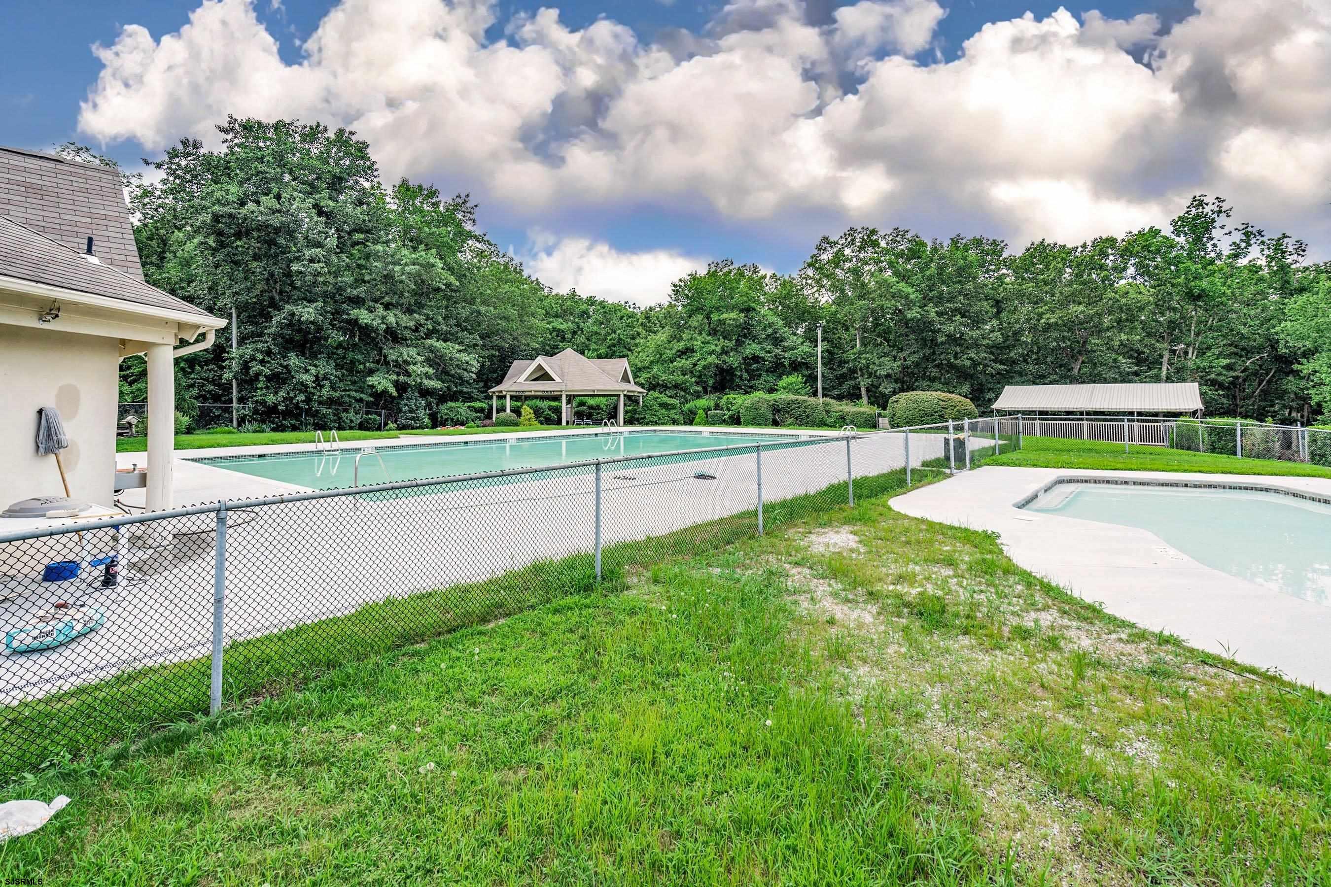 209 Daisy Court, Unit 209 Jackson, NJ 08527 - Photo 23 of 26 a view of a backyard with swimming pool