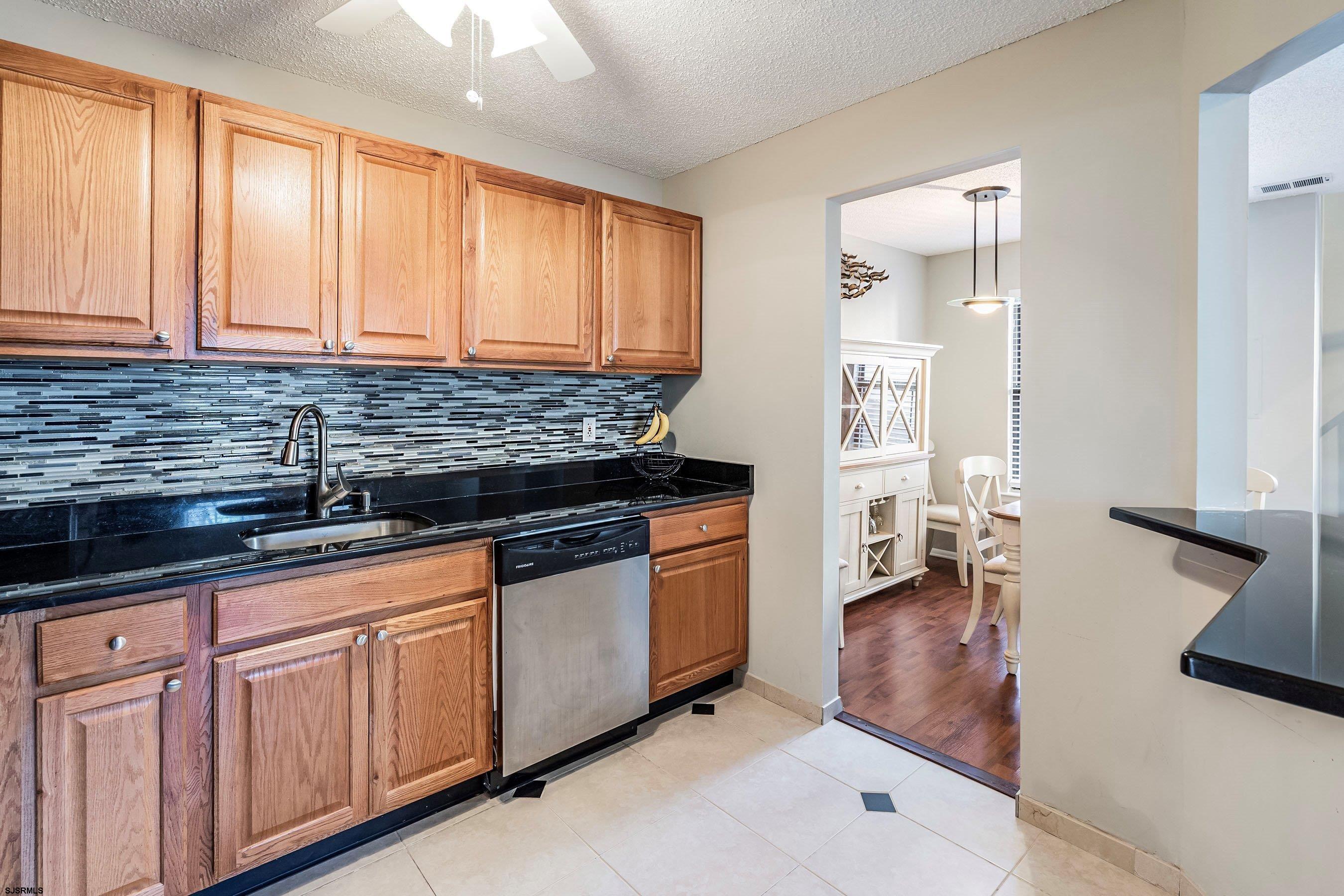 209 Daisy Court, Unit 209 Jackson, NJ 08527 - Photo 6 of 26 a kitchen with stainless steel appliances granite countertop a stove and a sink
