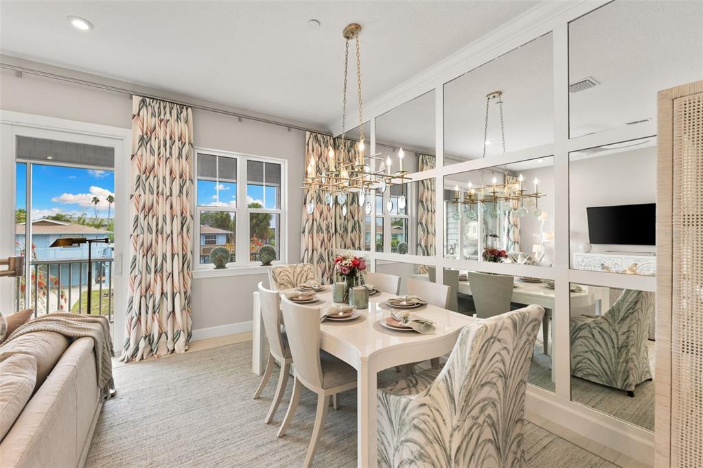 2503 Coral Court Indian Rocks Beach, FL 33785 - Photo 13 of 42 a dining room with furniture a chandelier and wooden floor