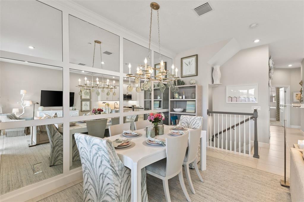 2503 Coral Court Indian Rocks Beach, FL 33785 - Photo 14 of 42 a view of a dining room and livingroom view with furniture wooden floor a chandelier