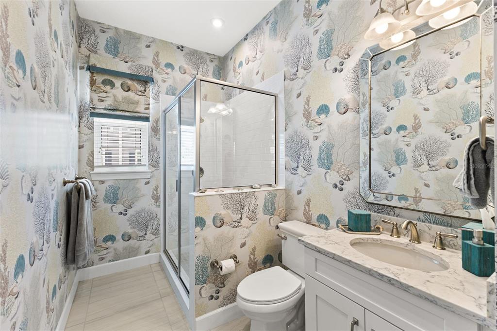 2503 Coral Court Indian Rocks Beach, FL 33785 - Photo 21 of 42 a bathroom with a granite countertop sink toilet and shower