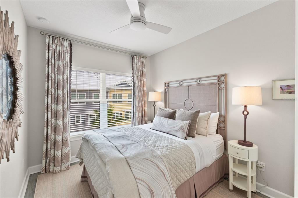 2503 Coral Court Indian Rocks Beach, FL 33785 - Photo 28 of 42 a bedroom with a large bed and a large window