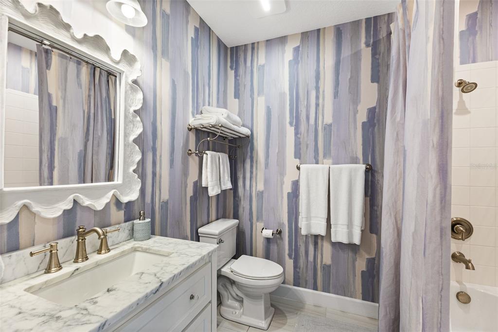 2503 Coral Court Indian Rocks Beach, FL 33785 - Photo 29 of 42 a bathroom with a granite countertop sink toilet and shower