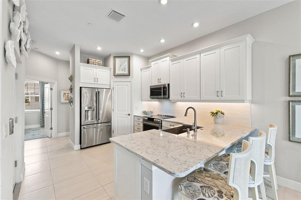 2503 Coral Court Indian Rocks Beach, FL 33785 - Photo 10 of 42 a kitchen with stainless steel appliances granite countertop a sink refrigerator and cabinets