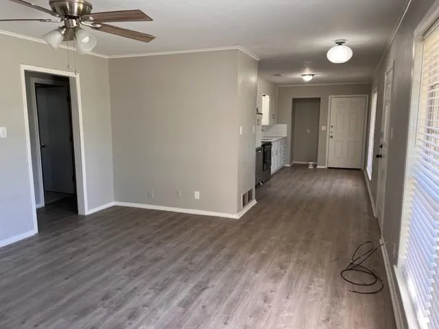 wooden floor in an empty room with a window