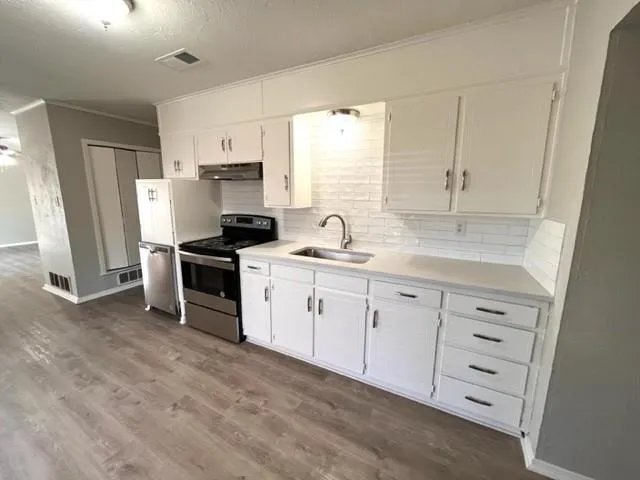 a kitchen with white cabinets and white appliances