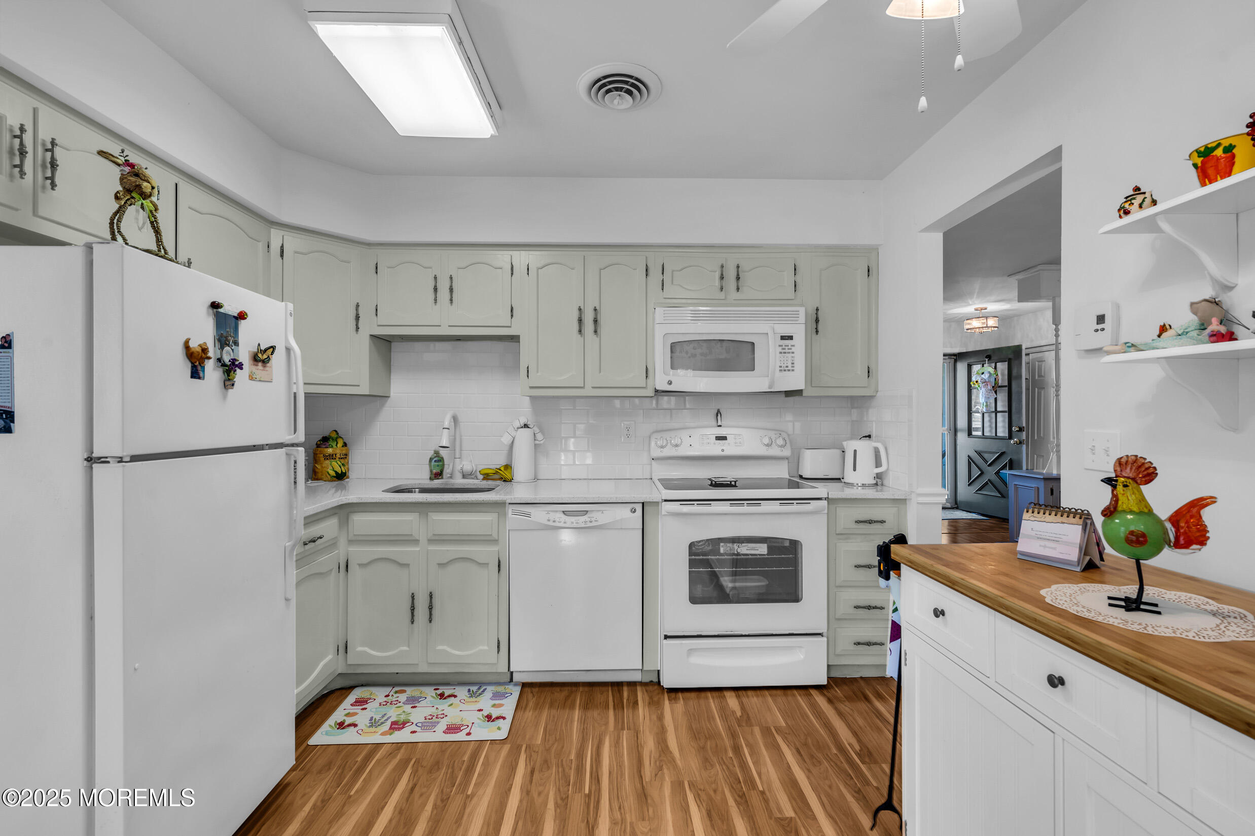 30 Sunset Road Whiting, NJ 08759 - Photo 13 of 31 a kitchen with a white cabinets and white appliances
