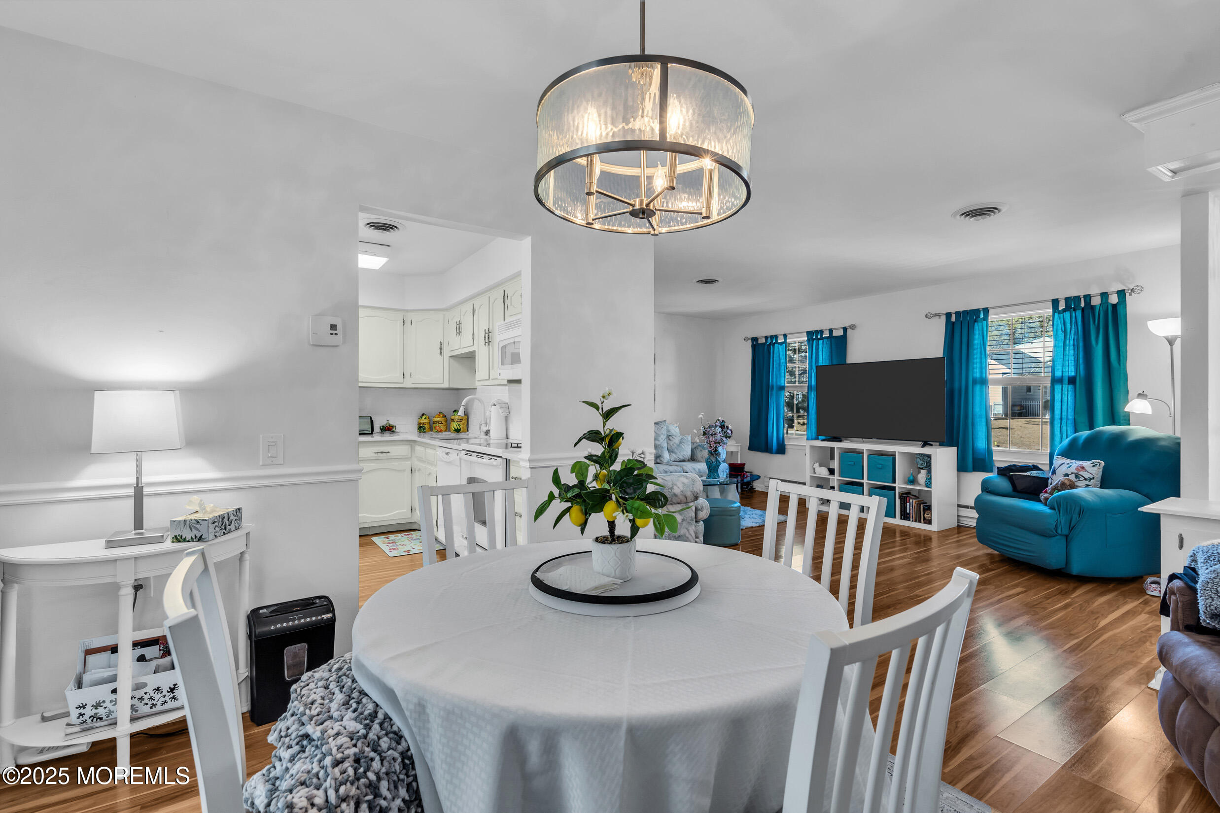 30 Sunset Road Whiting, NJ 08759 - Photo 8 of 31 a view of a dining room with furniture a chandelier and wooden floor