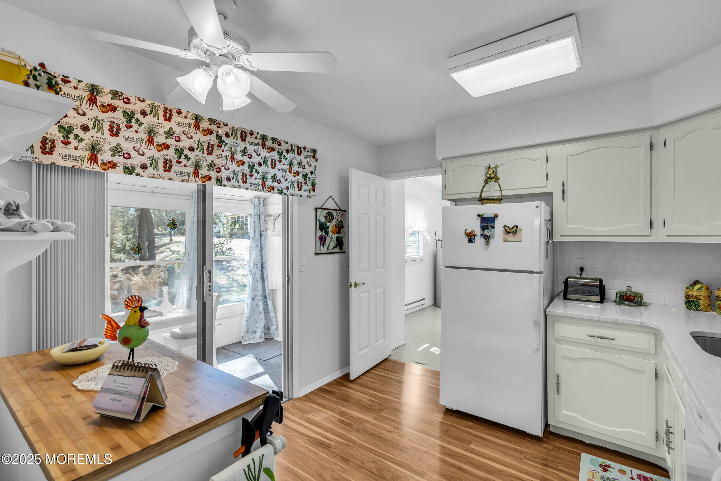 30 Sunset Road Whiting, NJ 08759 - Photo 10 of 31 a kitchen with stainless steel appliances granite countertop a refrigerator a sink dishwasher a stove a dining table and chairs with wooden floor
