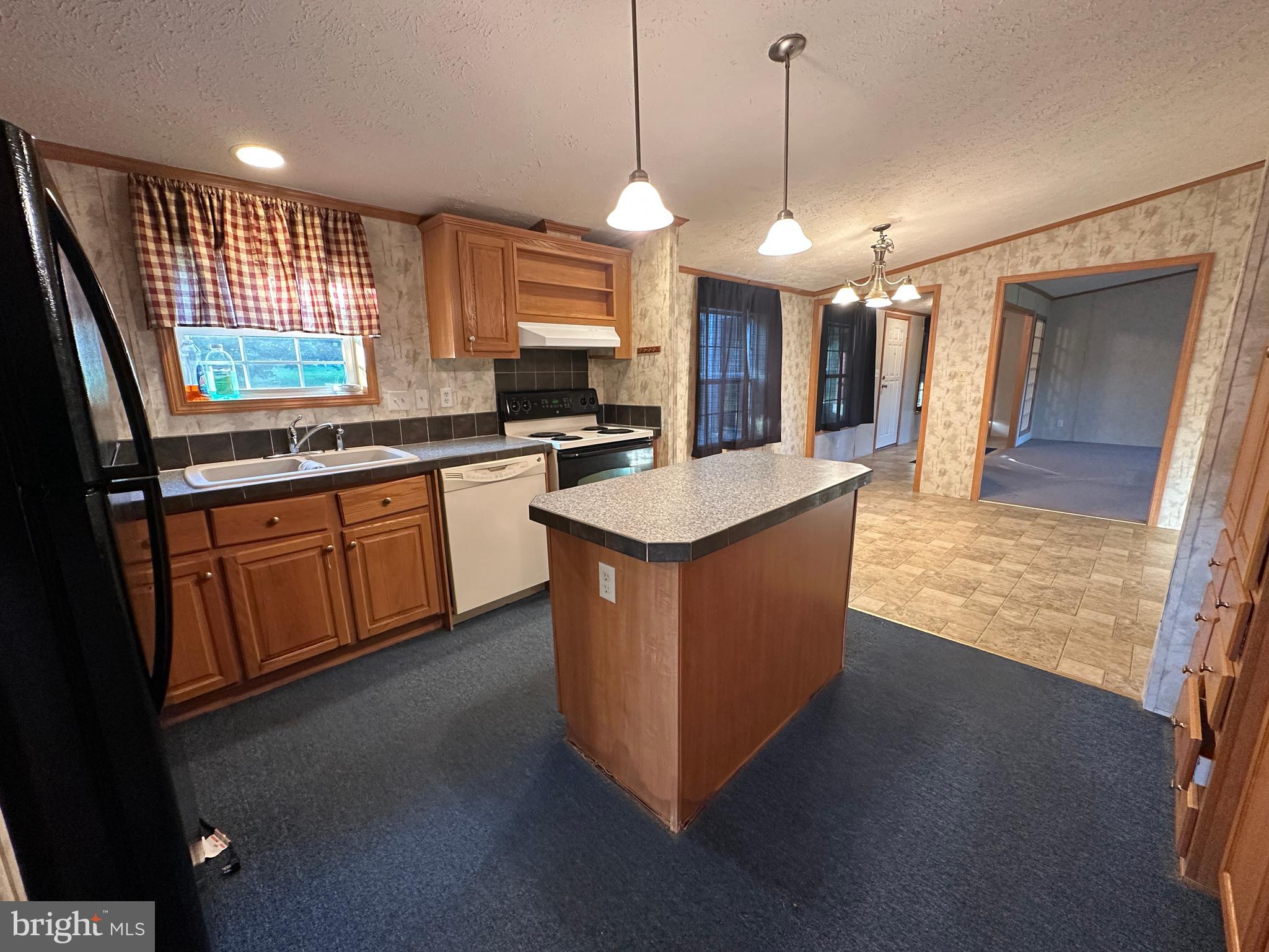 4391 Cito Road McConnellsburg, PA 17233 - Photo 39 of 67 a large kitchen with kitchen island white cabinets and stainless steel appliances