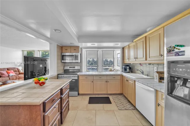 a kitchen with a sink a stove and cabinets