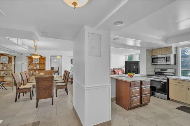 a view of a dining room with furniture and a kitchen