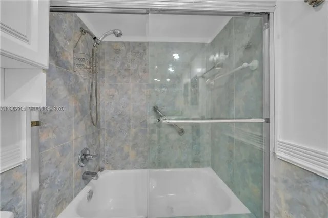 a view of a room with wooden floor and a window