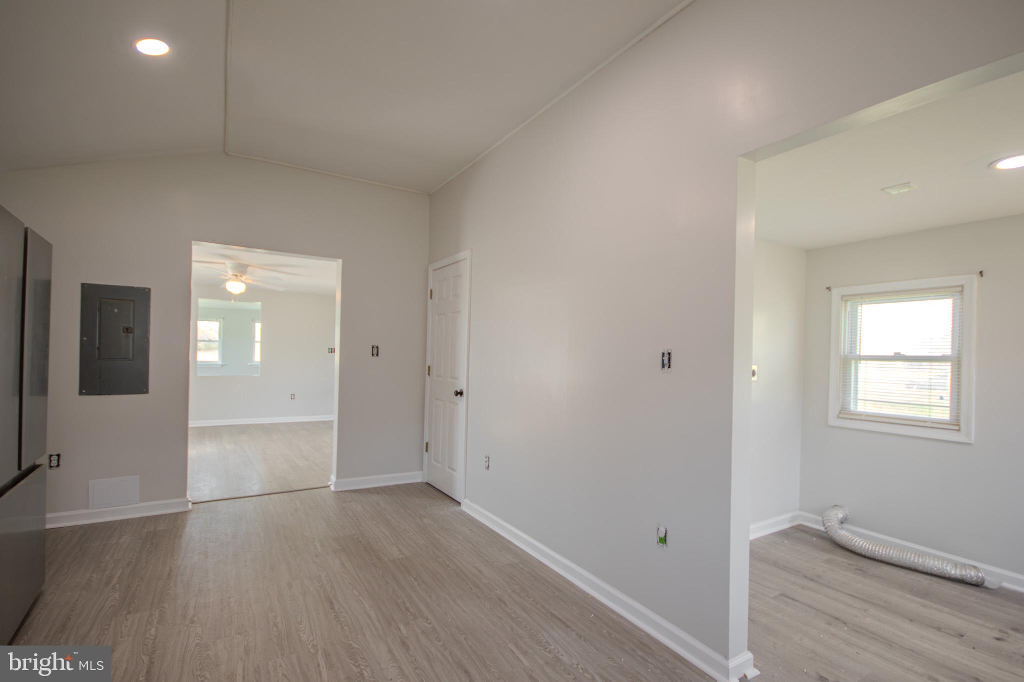 5693 Landon Store Road Marion Station, MD 21838 - Photo 5 of 20 wooden floor in an empty room with a window