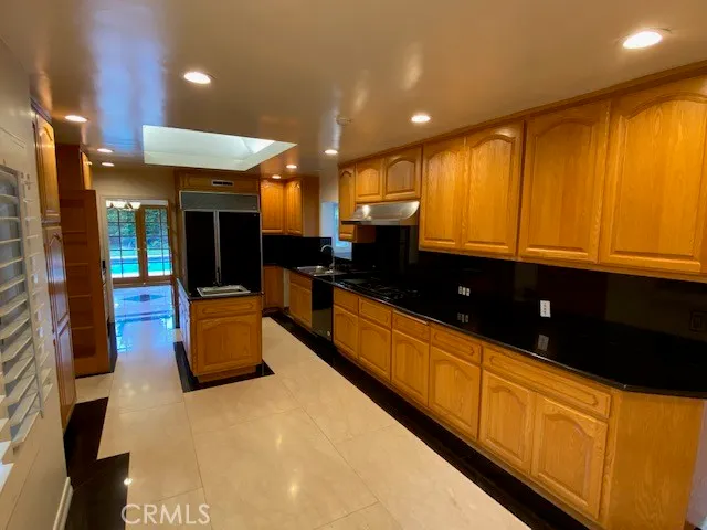 a large kitchen with stainless steel appliances a large counter top