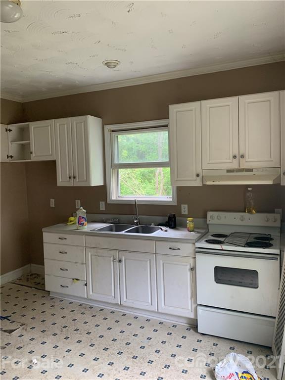 621 North Mountain Street Cherryville, NC 28021 - Photo 3 of 10 a kitchen with a stove a sink and a window