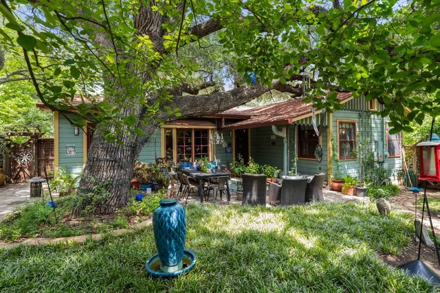 a view of a house with backyard sitting area and garden
