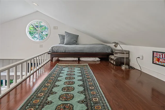 a view of a house with potted plants and a table and chairs