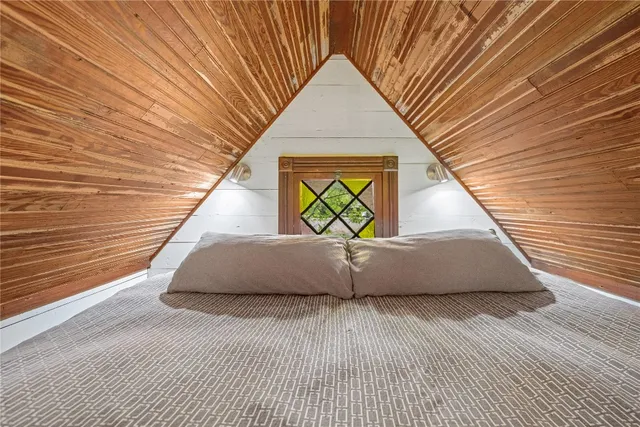 a view of a patio with table and chairs potted plants and large tree