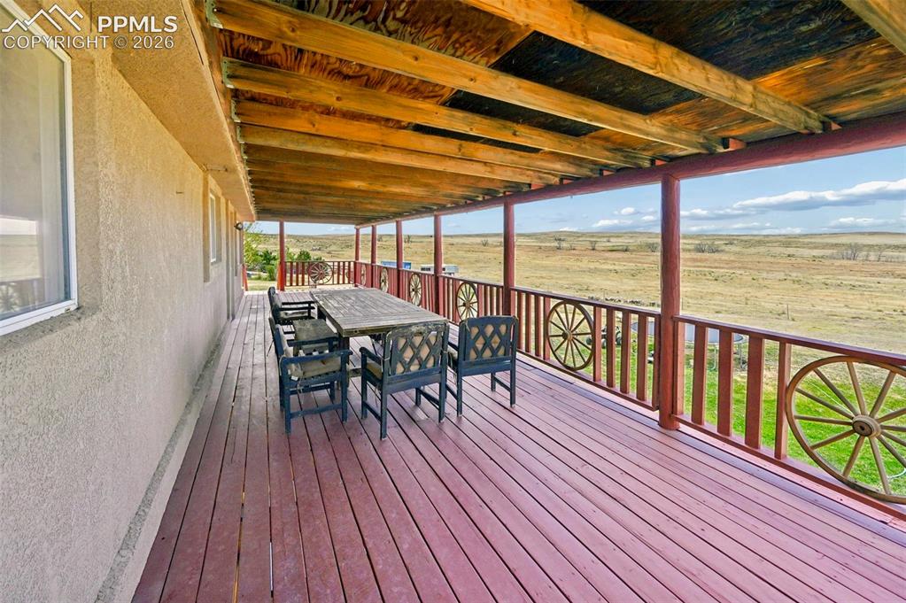 18560 Chelton Road Ramah, CO 80832 - Photo 9 of 34 a view of a table and chairs on roof deck