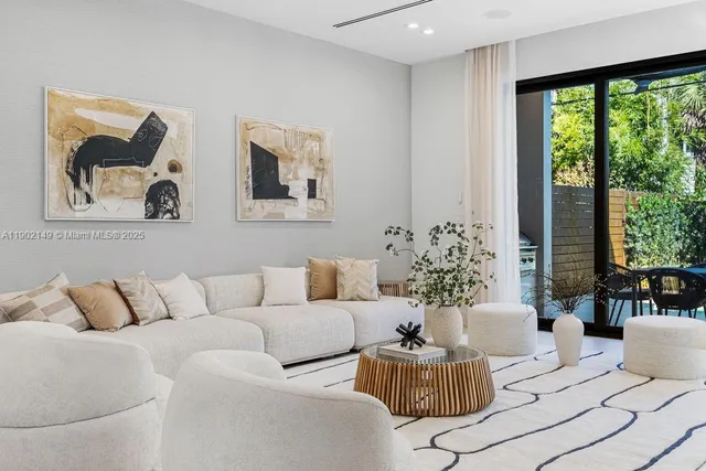 a white bath tub sitting in a bathroom next to a window