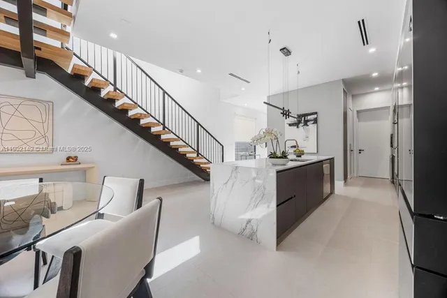 a kitchen with granite countertop a sink a stove and refrigerator
