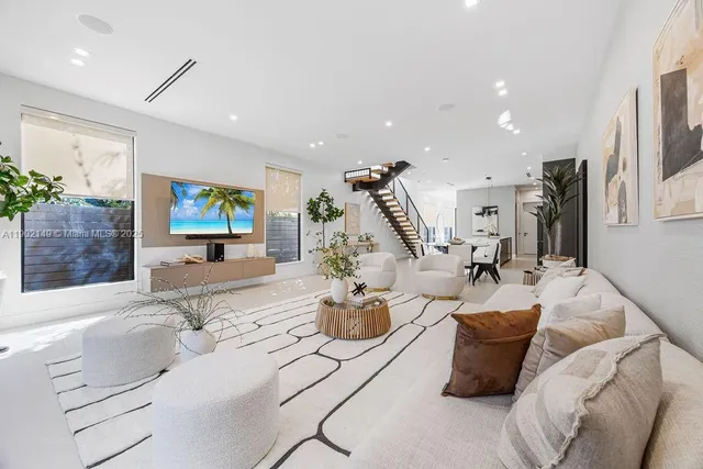 a view of a hallway with wooden floor and a bathroom