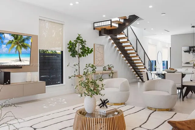 a spacious bedroom with a large bed and a large window