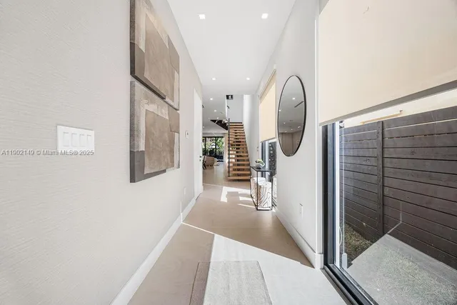 a view of a dining room with furniture and a potted plant
