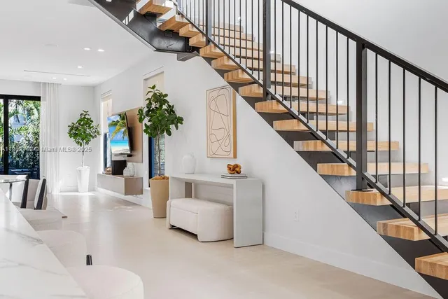 a bedroom with a large bed and a flat screen tv