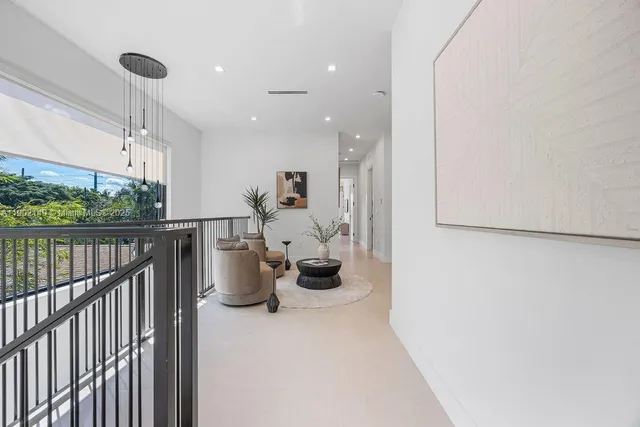 a bedroom with a large bed and a potted plant