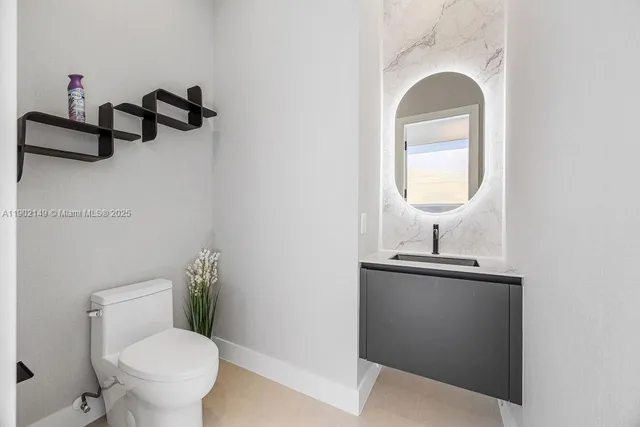 a kitchen with stainless steel appliances a sink and a refrigerator