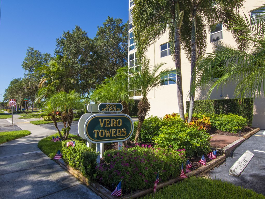 a sign that is sitting in front of flowers