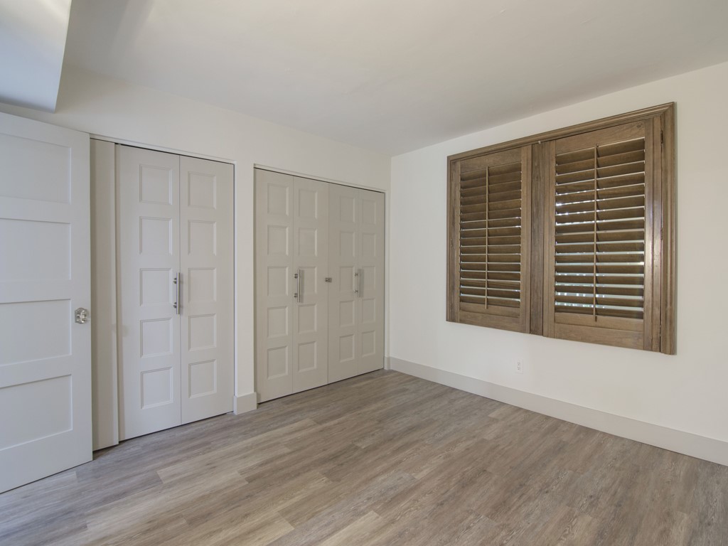 275 Date Palm Road, Unit 304 Vero Beach, FL 32963 - Photo 11 of 36 a view of an empty room with wooden floor and a window