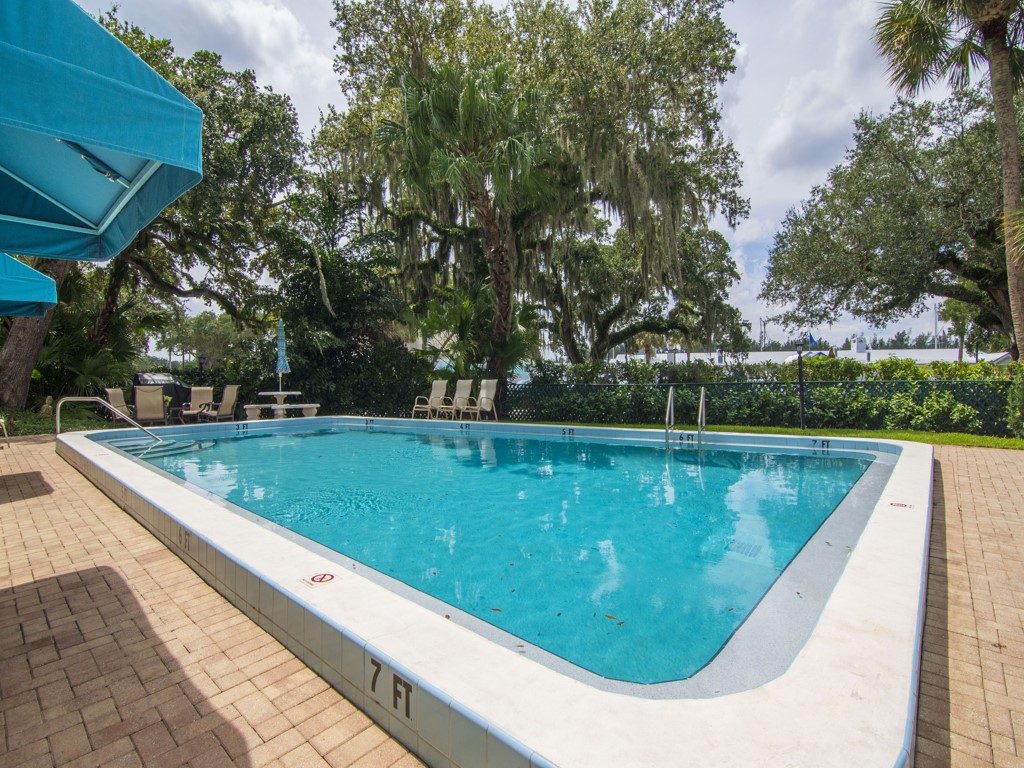 275 Date Palm Road, Unit 304 Vero Beach, FL 32963 - Photo 16 of 36 a view of swimming pool with a garden and trees