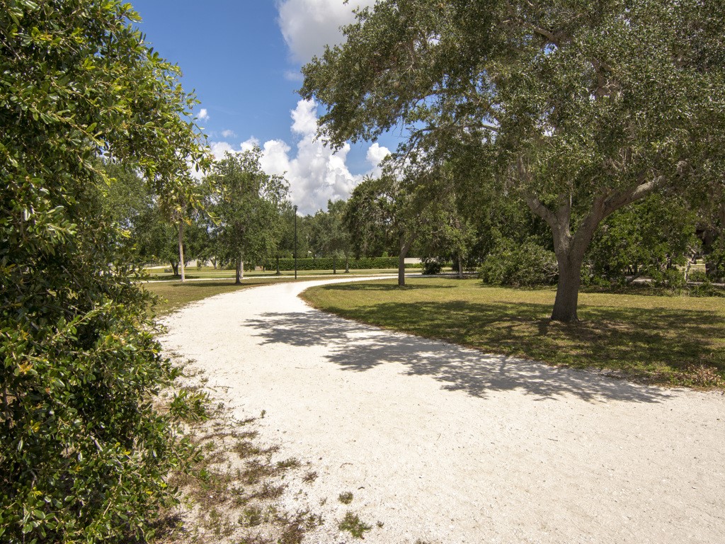 275 Date Palm Road, Unit 304 Vero Beach, FL 32963 - Photo 26 of 36 a view of a yard with large trees
